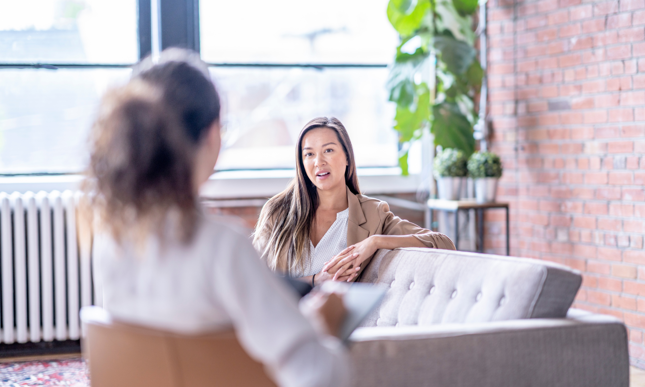 Hopeful young New Yorker contemplating therapy in Manhattan, cbt for anxiety nyc, cozy modern office setting, natural lighting Hopeful young New Yorker contemplating therapy in Manhattan, cbt for anxiety nyc, cozy modern office setting, natural lighting