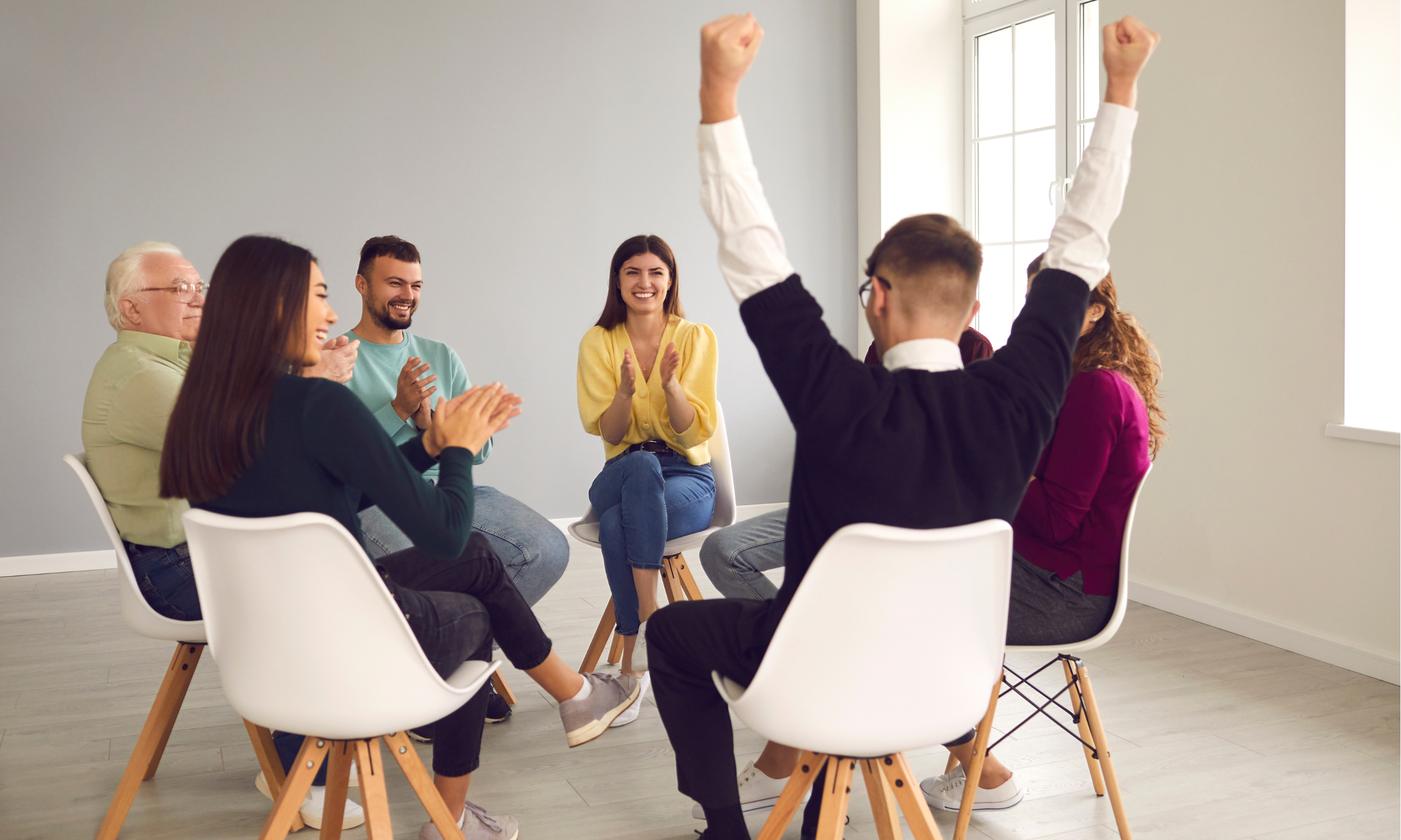 a diverse group, happily participating in a group therapy session
