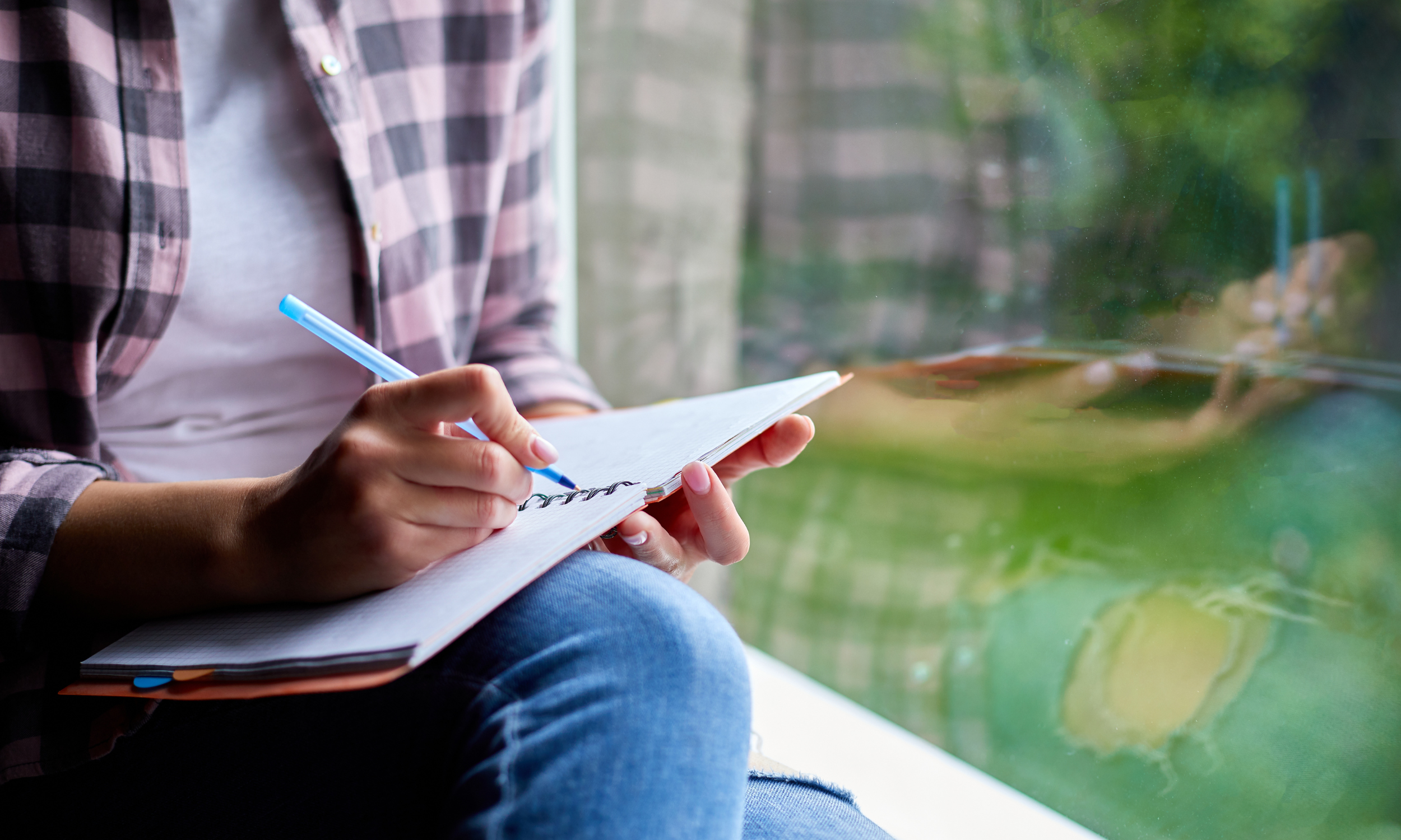 motivated young adult with determined expression journaling progress in a therapeutic setting — behavioral therapy for depression.