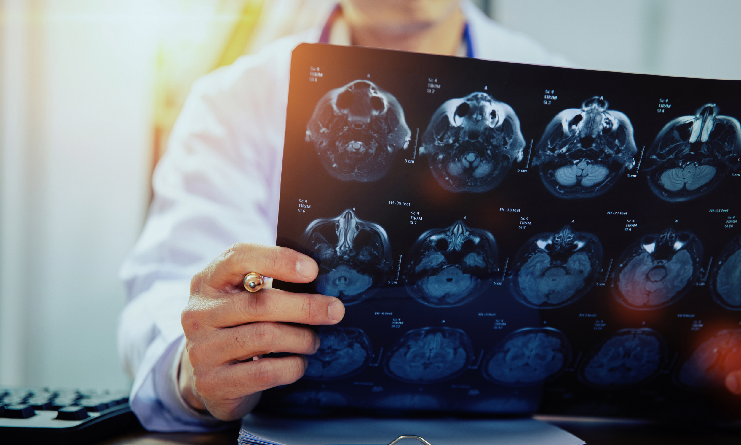 focused researcher analyzing brain scan data on a computer, highlighting evidence for behavioral therapy for depression.